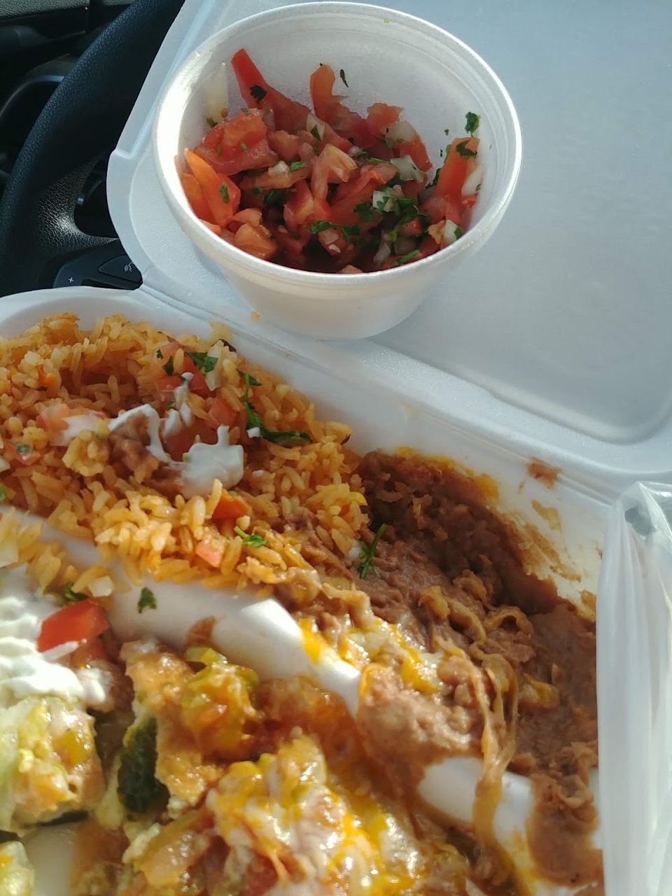 Printed menu with burritos, sides, and drinks.